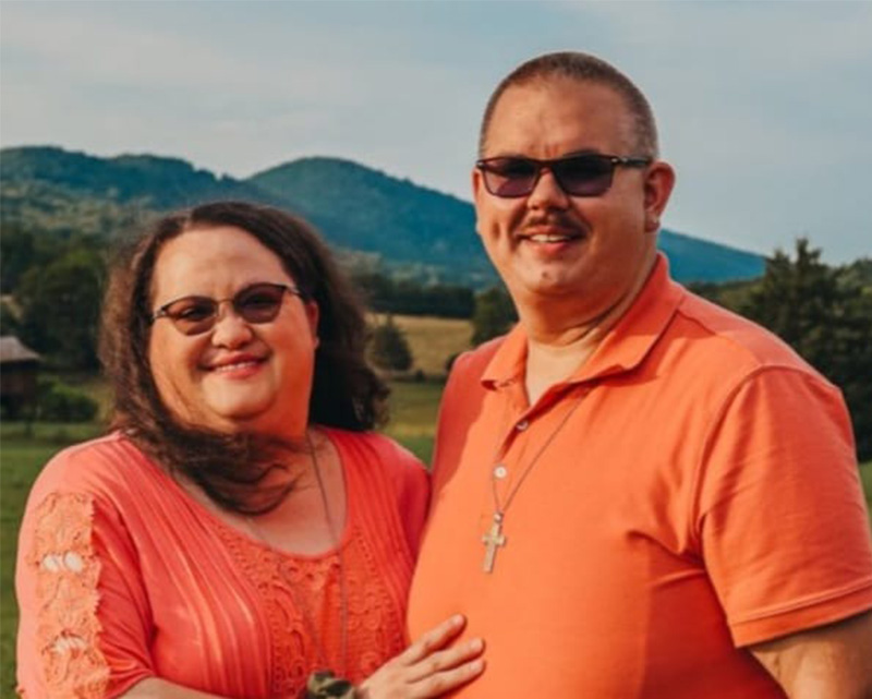 Ed Clemons, Jr. standing with his wife