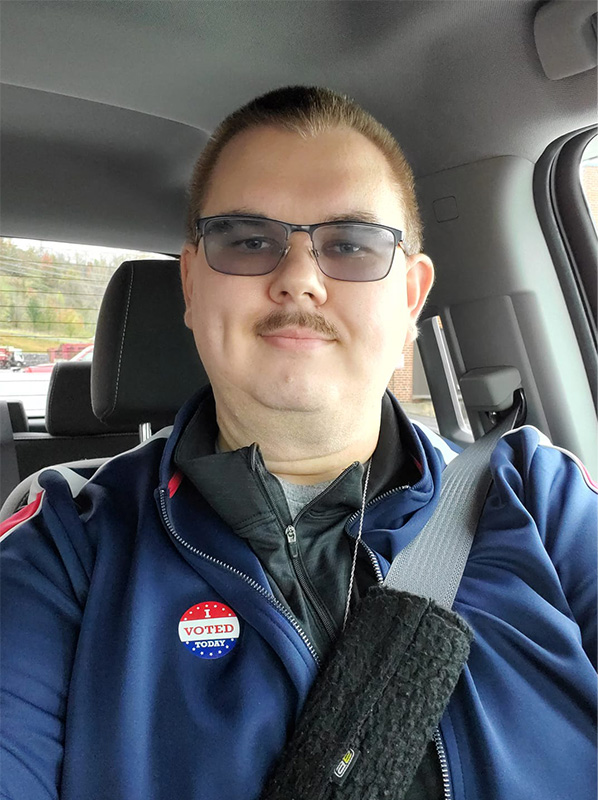Ed Clemons, Jr. sitting in his car after voting in an election
