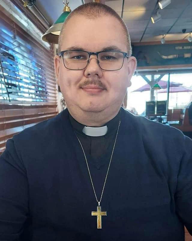 Ed Clemons, Jr. dressed in his pastor attire